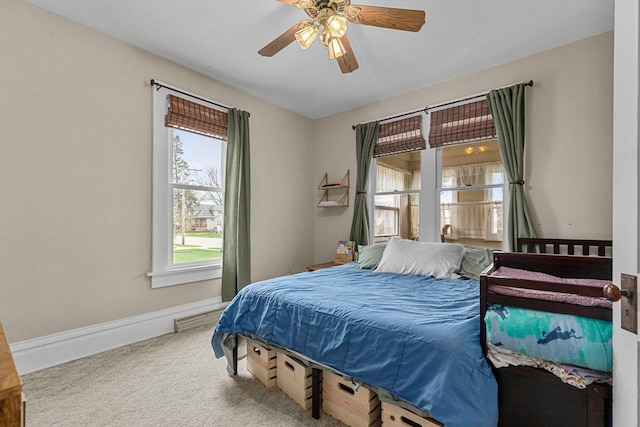 carpeted bedroom with baseboards and a ceiling fan