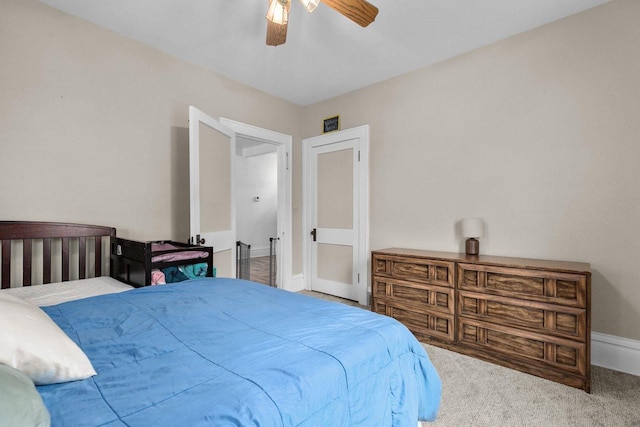 carpeted bedroom featuring ceiling fan and baseboards