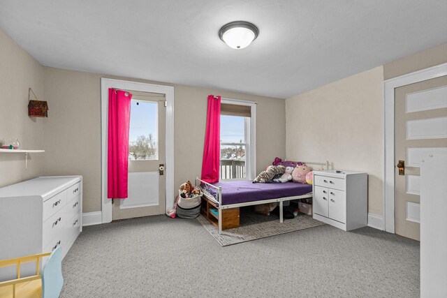 bedroom with baseboards and light carpet