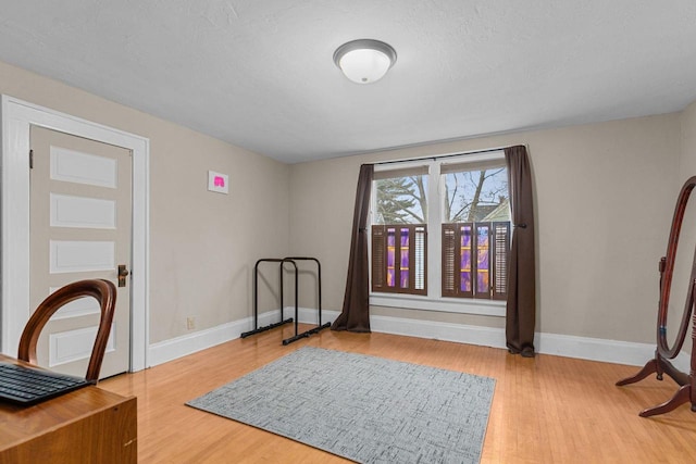 interior space with wood finished floors and baseboards