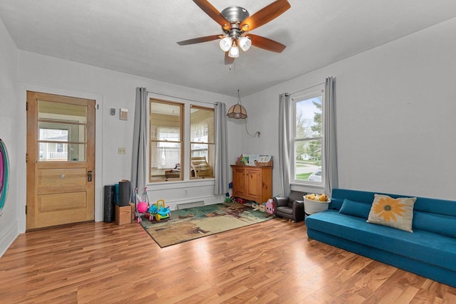 interior space featuring ceiling fan, a wealth of natural light, and wood finished floors