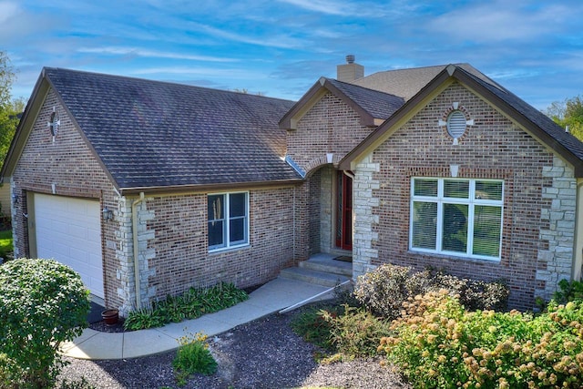 view of front of property featuring roof with shingles, an attached garage, a chimney, and brick siding