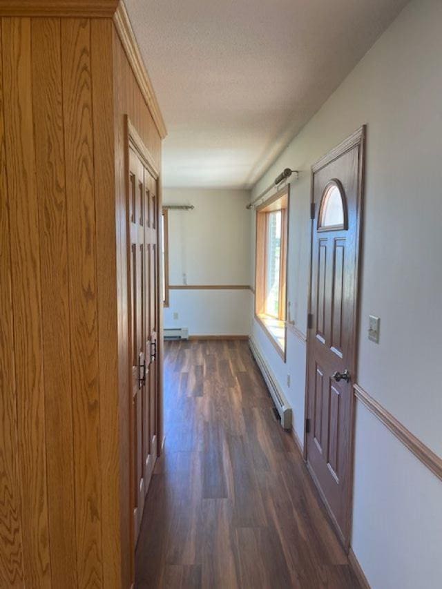 W8918 County Rd W, Crivitz, WI 54114 - foyer entrance featuring a baseboard heating unit, dark wood-style flooring, baseboards, a baseboard radiator, and a textured ceiling