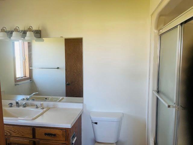 W8918 County Rd W, Crivitz, WI 54114 - full bath with toilet, vanity, and a shower with shower door