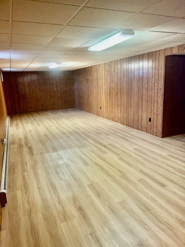 W8918 County Rd W, Crivitz, WI 54114 - finished basement featuring a drop ceiling, wood finished floors, and wooden walls
