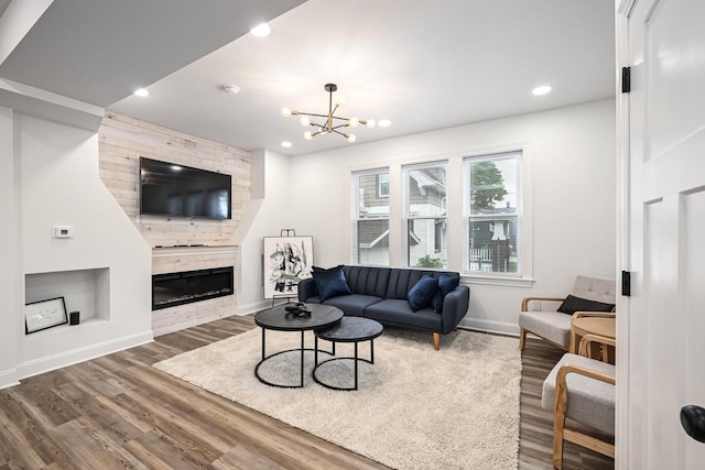 1928 E Iron St, Milwaukee, WI 53207 - living room featuring wood finished floors, a fireplace, a notable chandelier, baseboards, and recessed lighting