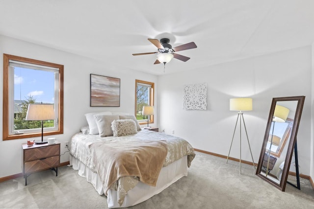 carpeted bedroom featuring ceiling fan and baseboards