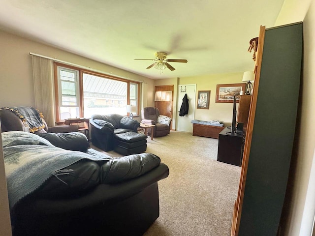 living area featuring carpet flooring and ceiling fan