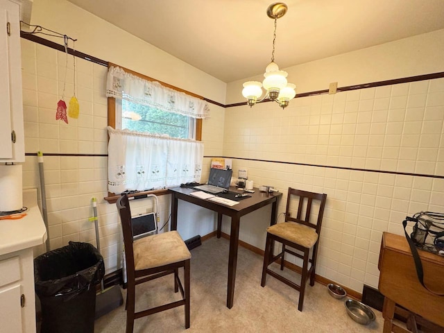 office area featuring tile walls, light carpet, and an inviting chandelier