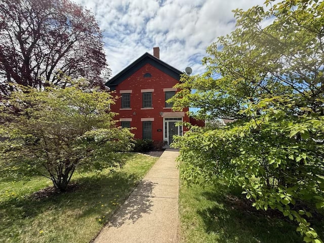 320 W Harrison St, Shullsburg, WI 53586 - view of home's exterior with a chimney and brick siding
