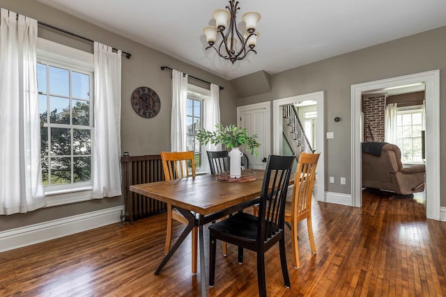 320 W Harrison St, Shullsburg, WI 53586 - dining space with baseboards, stairs, a notable chandelier, and wood-type flooring