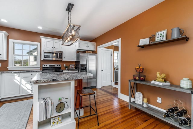 320 W Harrison St, Shullsburg, WI 53586 - kitchen featuring a kitchen breakfast bar, white cabinetry, dark wood-style floors, appliances with stainless steel finishes, and recessed lighting