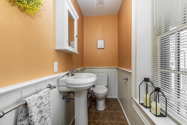 320 W Harrison St, Shullsburg, WI 53586 - half bath featuring tile patterned floors, a wainscoted wall, and toilet