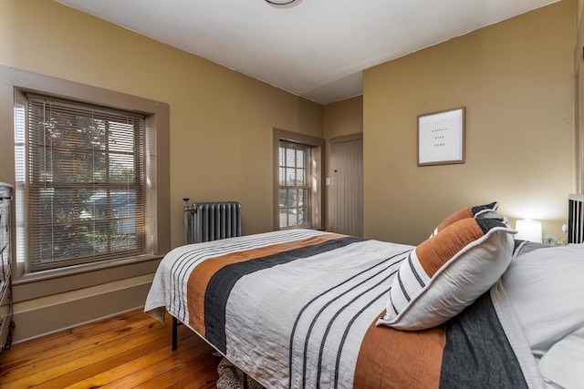 320 W Harrison St, Shullsburg, WI 53586 - bedroom with radiator heating unit and hardwood / wood-style flooring