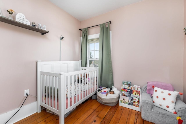 320 W Harrison St, Shullsburg, WI 53586 - bedroom with hardwood / wood-style floors and a crib