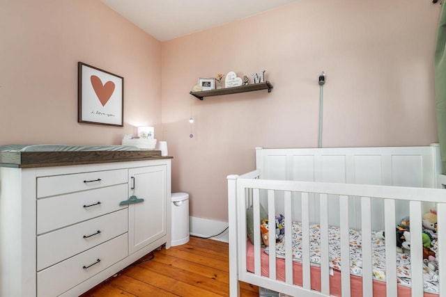320 W Harrison St, Shullsburg, WI 53586 - bedroom featuring a crib and light wood-type flooring