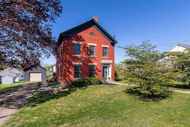320 W Harrison St, Shullsburg, WI 53586 - traditional-style home with an outdoor structure, brick siding, a front lawn, a chimney, and dirt driveway