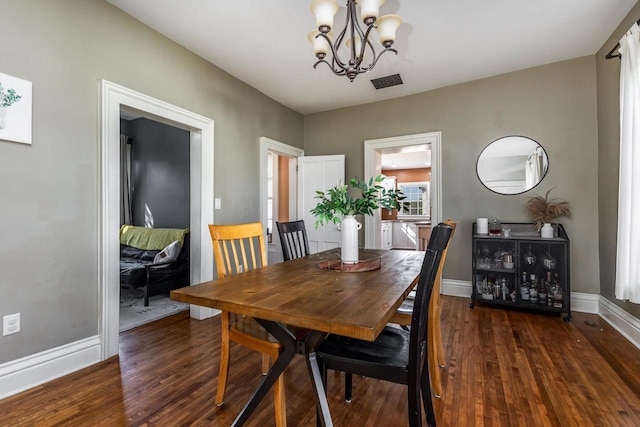 320 W Harrison St, Shullsburg, WI 53586 - dining area with a chandelier, baseboards, visible vents, and wood finished floors