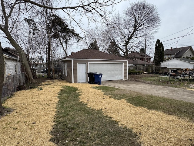 detached garage featuring fence
