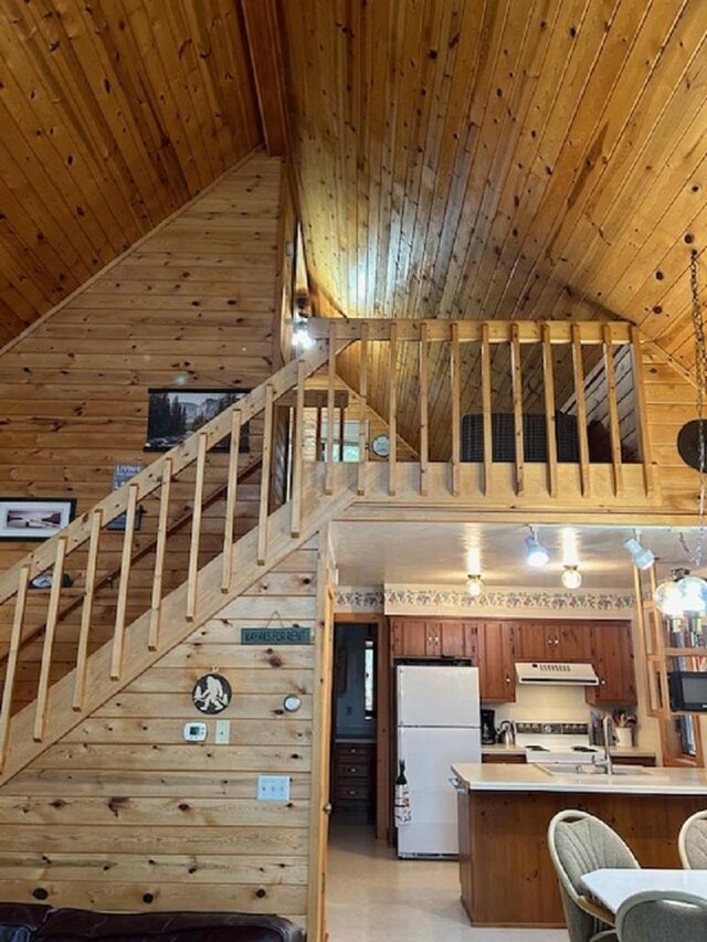 W15560 Mckinley Ln, Athelstane, WI 54104 - kitchen featuring wood ceiling, high vaulted ceiling, freestanding refrigerator, range hood, and wood walls