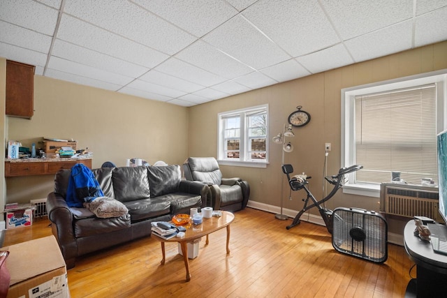 3423 S Clement Ave, Milwaukee, WI 53207 - living room featuring baseboards, a drop ceiling, and light wood-style flooring