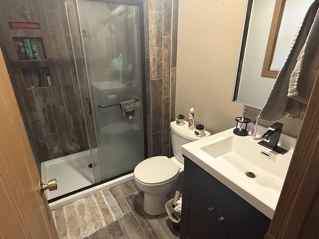 W5417 Volling Ln, Mauston, WI 53948 - full bathroom featuring vanity, toilet, a stall shower, and wood finished floors