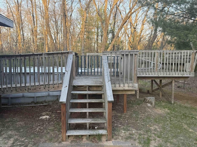W5417 Volling Ln, Mauston, WI 53948 - wooden deck with stairway and view of wooded area
