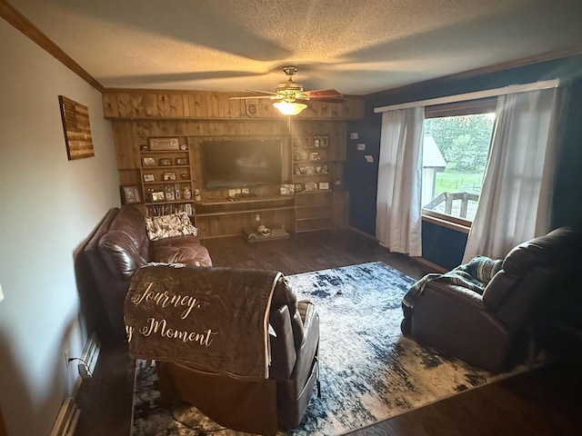 W5417 Volling Ln, Mauston, WI 53948 - living room featuring a textured ceiling, ceiling fan, wooden walls, wood finished floors, and baseboards