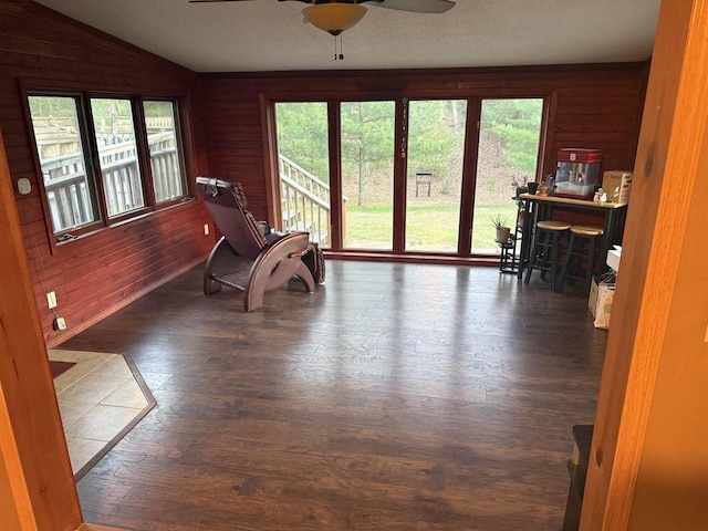 W5417 Volling Ln, Mauston, WI 53948 - living area featuring ceiling fan, lofted ceiling, wood-type flooring, and wooden walls