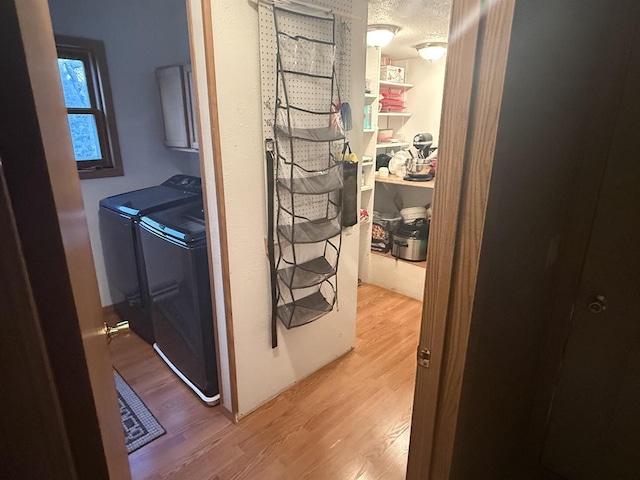 W5417 Volling Ln, Mauston, WI 53948 - laundry area with wood finished floors, separate washer and dryer, and a textured ceiling