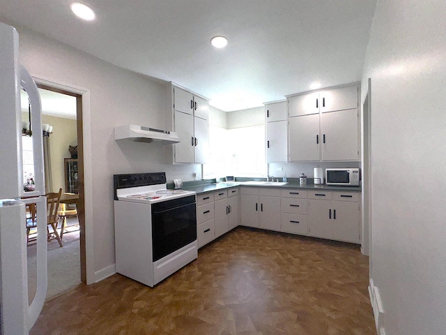 140 W Manchester St, Markesan, WI 53946 - kitchen featuring recessed lighting, under cabinet range hood, white range with electric stovetop, a sink, and white cabinets