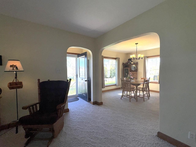 140 W Manchester St, Markesan, WI 53946 - corridor with a chandelier, carpet flooring, arched walkways, and baseboards