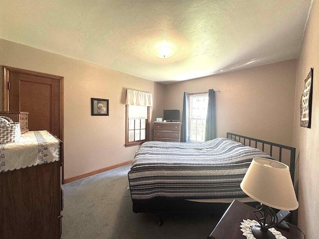 140 W Manchester St, Markesan, WI 53946 - bedroom with a textured ceiling, baseboards, and carpet floors