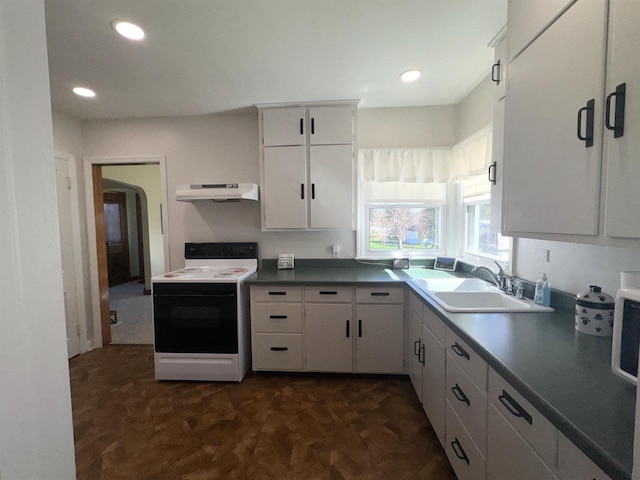 140 W Manchester St, Markesan, WI 53946 - kitchen with under cabinet range hood, white cabinetry, a sink, and range with electric cooktop