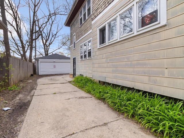 2753 N 60th St Unit 2755, Milwaukee, WI 53210 - view of home's exterior featuring an outbuilding, fence, and a detached garage