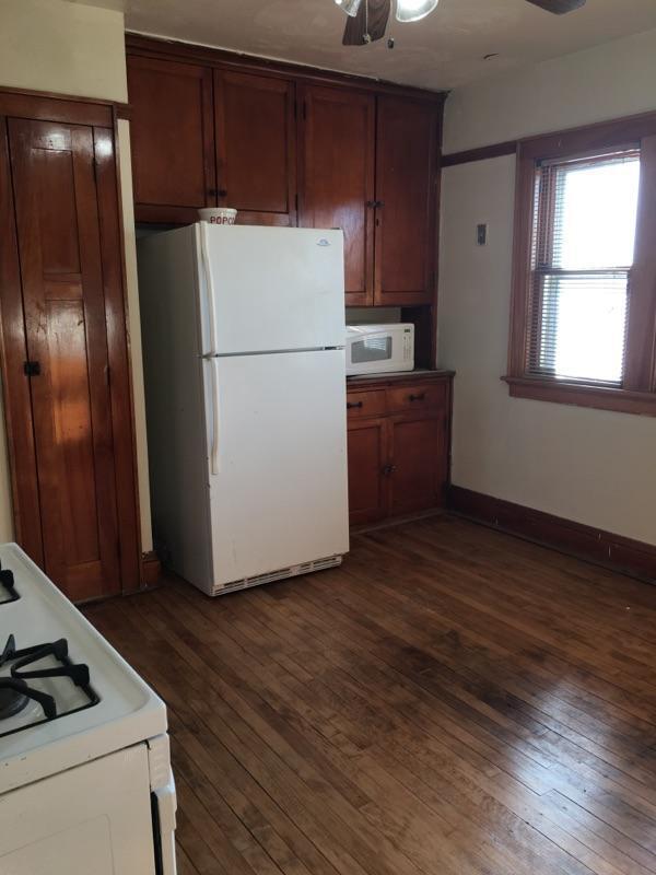 2753 N 60th St Unit 2755, Milwaukee, WI 53210 - kitchen featuring baseboards, dark wood-style flooring, white appliances, and ceiling fan