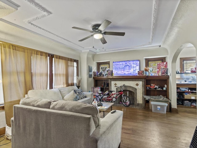 2753 N 60th St Unit 2755, Milwaukee, WI 53210 - living room featuring a ceiling fan, wood finished floors, arched walkways, a raised ceiling, and a fireplace