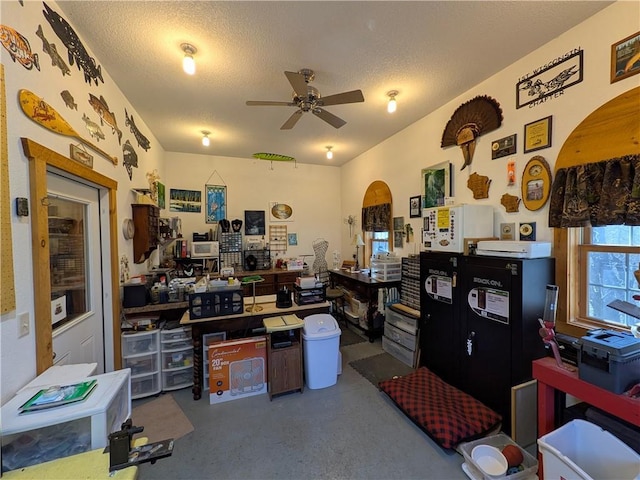 1380 101st Cir, Amery, WI 54001 - miscellaneous room with arched walkways, a ceiling fan, a textured ceiling, and concrete floors