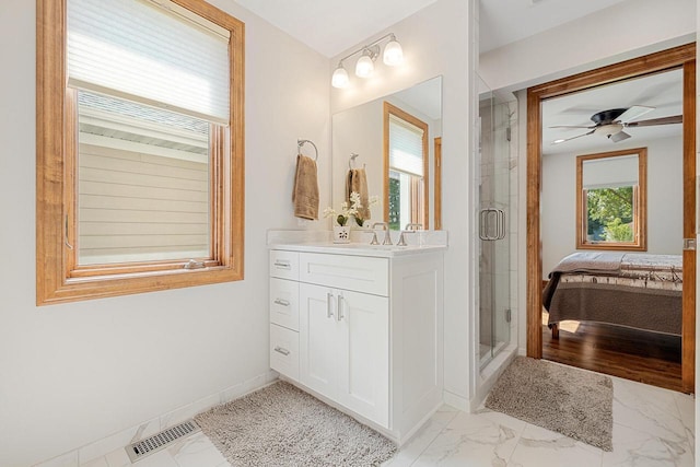 1430 Park Ave, West Bend, WI 53090 - full bathroom with marble finish floors, a shower stall, vanity, and ensuite bathroom