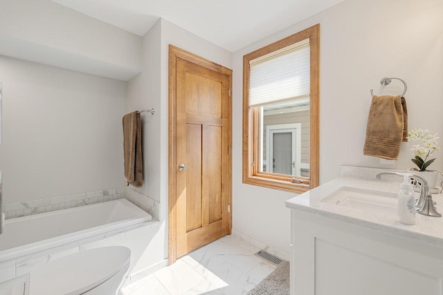 1430 Park Ave, West Bend, WI 53090 - full bath with marble finish floors, a bath, vanity, toilet, and baseboards