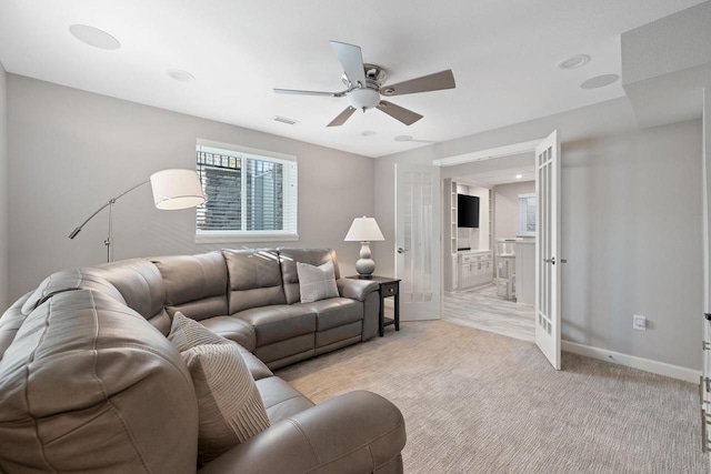 1430 Park Ave, West Bend, WI 53090 - living area featuring ceiling fan, french doors, light carpet, and baseboards