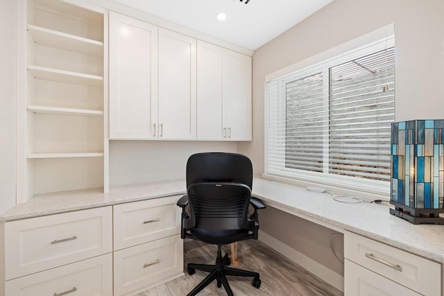 1430 Park Ave, West Bend, WI 53090 - office with built in desk, light wood-style flooring, healthy amount of natural light, and baseboards