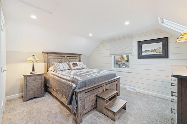 1430 Park Ave, West Bend, WI 53090 - bedroom featuring vaulted ceiling, a skylight, light carpet, wood walls, and recessed lighting