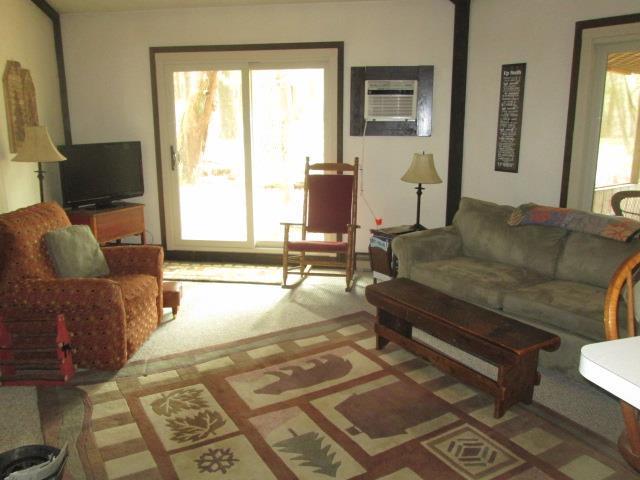 N3880 Deer Path, Hancock, WI 54943 - carpeted living area with an AC wall unit