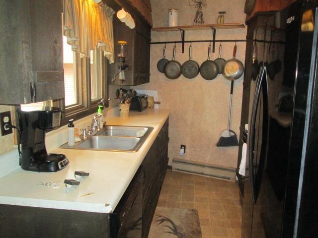 N3880 Deer Path, Hancock, WI 54943 - kitchen with freestanding refrigerator, a sink, a baseboard radiator, and light countertops