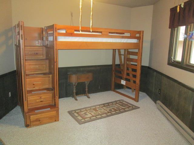 N3880 Deer Path, Hancock, WI 54943 - bedroom with carpet floors, wainscoting, and baseboard heating