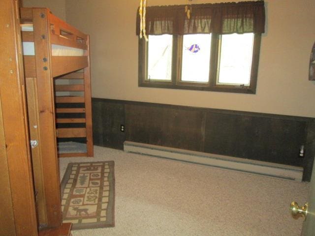 N3880 Deer Path, Hancock, WI 54943 - unfurnished bedroom with a baseboard radiator and carpet flooring