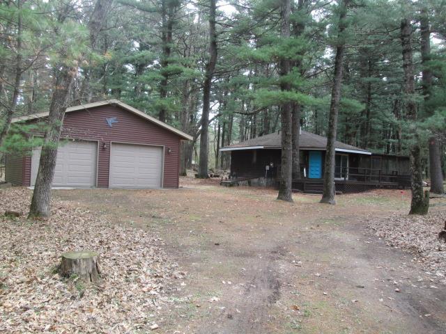 N3880 Deer Path, Hancock, WI 54943 - view of property exterior featuring an outbuilding and a garage
