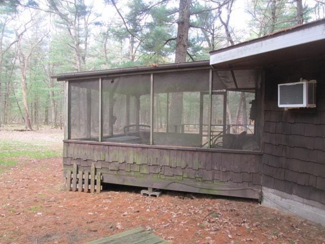 N3880 Deer Path, Hancock, WI 54943 - view of side of property featuring a sunroom and a wall unit AC