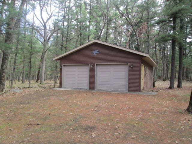 N3880 Deer Path, Hancock, WI 54943 - detached garage featuring a wooded view